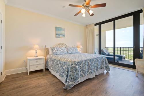 Un dormitorio con una cama y un ventilador de techo. en 204 Holiday Isle, en Dauphin Island
