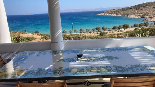 a table on a balcony with a view of the ocean at casa koklakura in Lipsoi