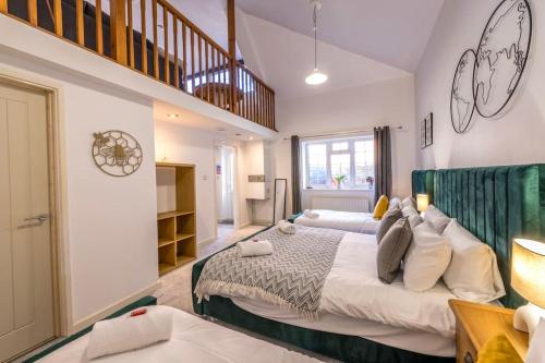 a bedroom with two beds and a staircase at Centralised Admiralty Terrace with FREE PARKING by Prescott Apartments in Bristol