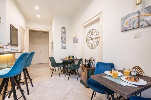 a dining room with blue chairs and a table at Park&Art Boutique Suites in Budapest