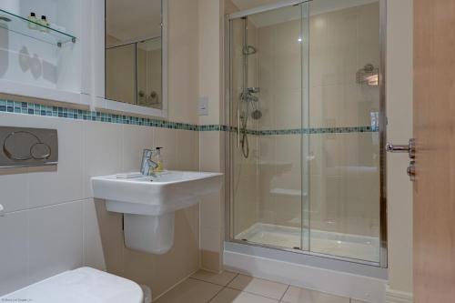 a bathroom with a shower and a sink and a toilet at The Foundry in Oxford