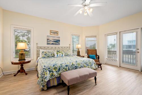 a bedroom with a bed and a ceiling fan at 025 The Sanderling in Dauphin Island