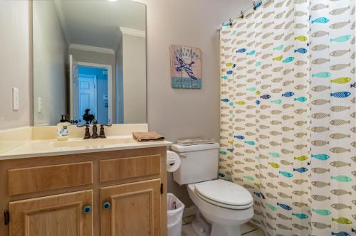 un bagno con un water e una tenda da doccia di 073 Coastal Cottage a Dauphin Island