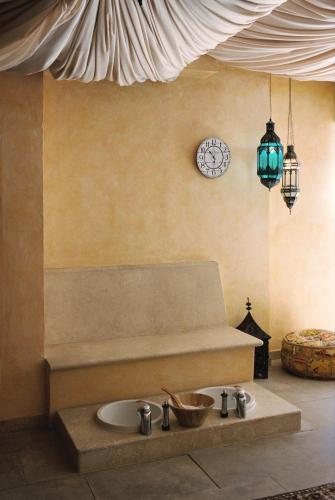 a bathroom with a sink and a clock on the wall at Hotel Bon Sol Resort & Spa in Illetas