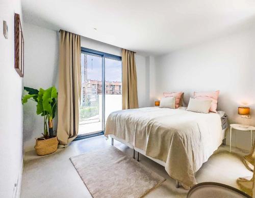 a bedroom with a bed and a large window at 96-brand new apartment, Fuengirola in Fuengirola