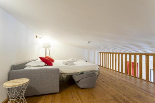a small bedroom with a bed and a table at Gressoney Saint-Jean apartments by Halldis in Gressoney-Saint-Jean