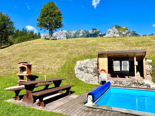 a backyard with a pool and a picnic table at Haus Bergwelten Ramsau - Hintermühle in Ramsau