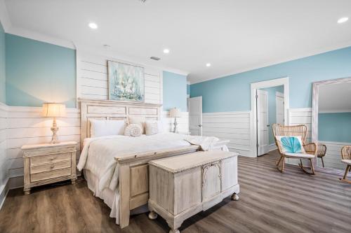 a bedroom with a bed and a table and chairs at 011 The Blue Heron in Dauphin Island