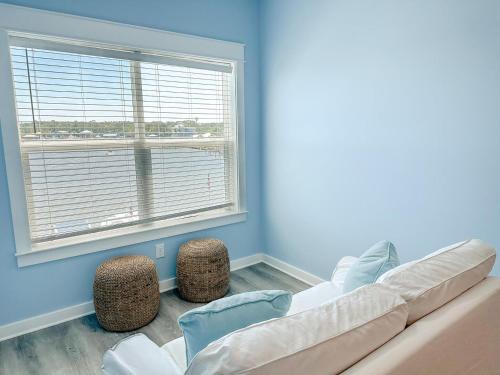 a living room with a couch and a large window at 011 The Blue Heron in Dauphin Island