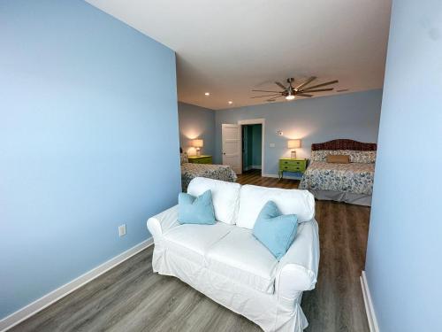 a living room with a couch and a bedroom at 011 The Blue Heron in Dauphin Island
