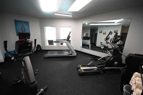a gym with several exercise bikes and a mirror at Edgewater Inn and Suites, an Ascend Collection Hotel in Coos Bay