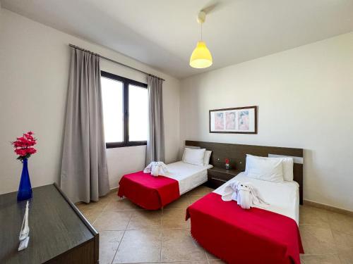 a hotel room with two beds and a window at Casa Maddy - A charming location with every comfort in Playa Blanca