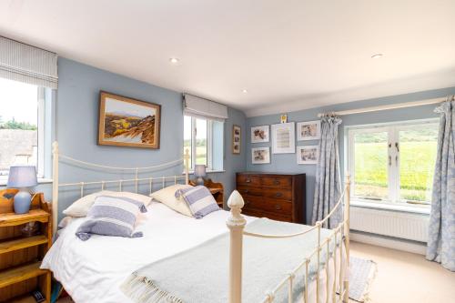 a bedroom with a bed and a window at Poachers Lodge At Tapnell Farm in Yarmouth