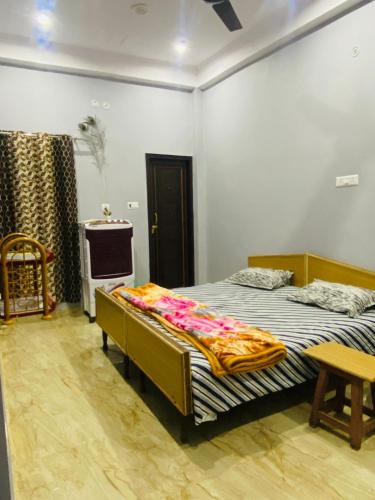 a bedroom with two beds and a table and a tv at Dreams Stay in Lucknow