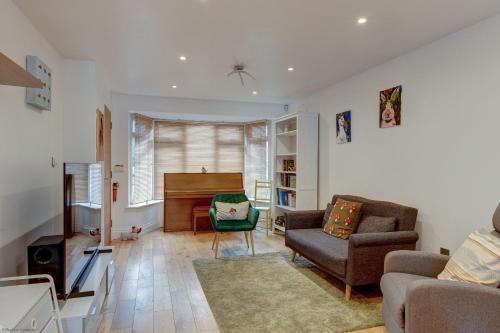 a living room with a piano and a couch at Lillies House in Oxford