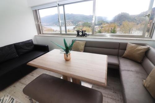 a living room with a coffee table and a couch at Casa Panorâmica Gerês by Gerês Casas in Geres