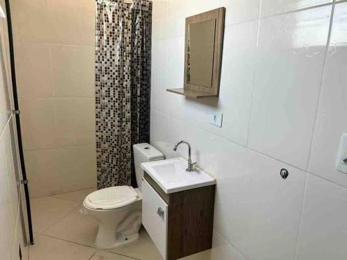 a bathroom with a toilet and a sink and a shower at Studio Aconchegante Ao lado Expo Center Norte SP in São Paulo