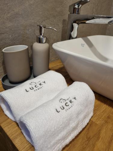 two towels on a counter next to a sink at Lucky Chalet Jasná luxury apartment in Demanovska Dolina