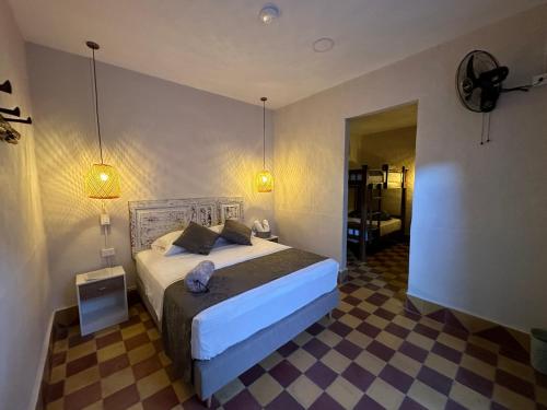 a bedroom with a bed and a checkered floor at CASA HOTEL LAS HORTENSIAS in Jardin