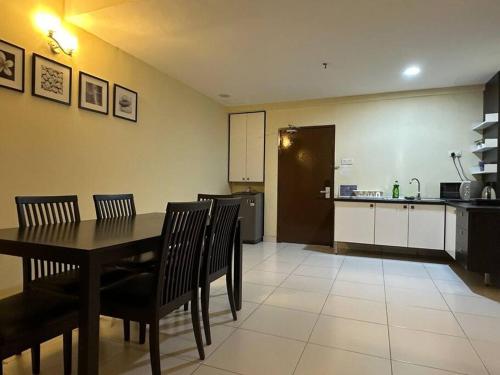 a kitchen and dining room with a table and chairs at Bayu Marina Resort 3 Bedroom in Johor Bahru