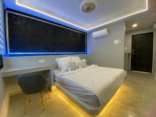 a bedroom with a bed and a desk and a chalkboard at I Do Farmstay in Bukit Mertajam
