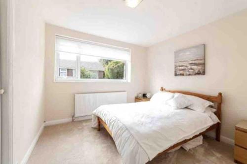 a bedroom with a large bed and a window at Hyde Park Apartment in London