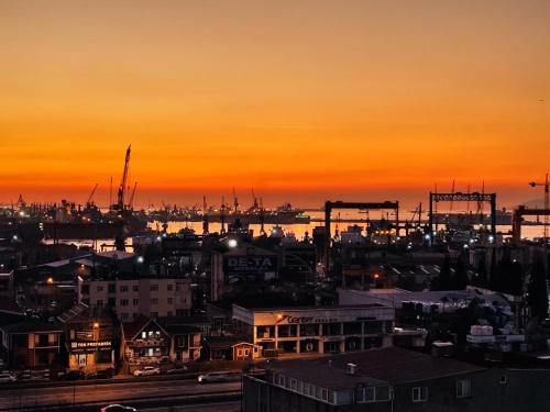 a city skyline with a sunset in the background at PETRA HOTEL TUZLA in Tuzla