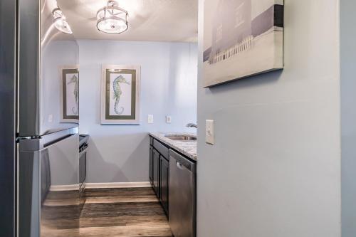 a kitchen with a refrigerator and a sink at Ocean Bliss Cottage! Beach Club Villa with Canal Views - Short walk to Beach in Fripp Island