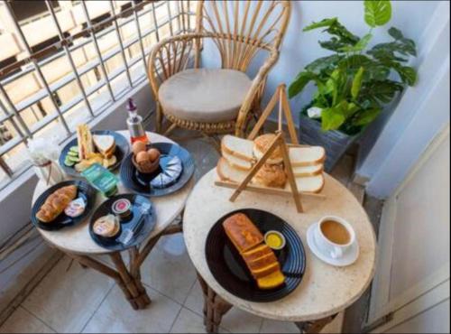 a balcony with two tables with plates of food at City inn Cairo hostel Caca in Cairo
