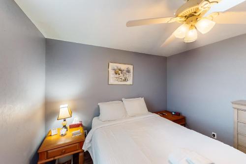 a bedroom with a bed and a ceiling fan at Island Retreat in St. George Island
