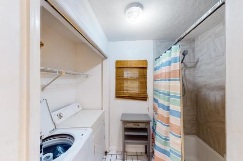 a bathroom with a washing machine and a shower at Island Retreat in St. George Island