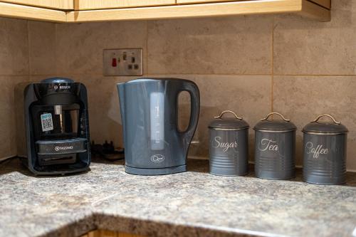 a group of three coffee cups sitting on a counter at Large studio 2min to hendon Central Station in The Hyde