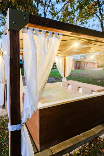 a wooden bed with curtains and a canopy at Due Ponti Village in Cesenatico