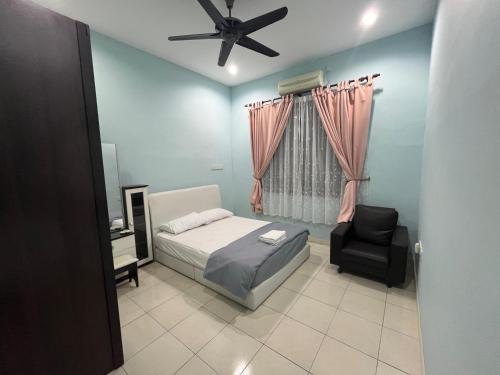 a bedroom with a bed and a chair at JZ at Sungai Besar Single Storey Semi-D in Sungai Besar