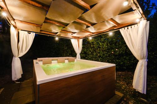 a jacuzzi tub with lights under a tent at Due Ponti Village in Cesenatico