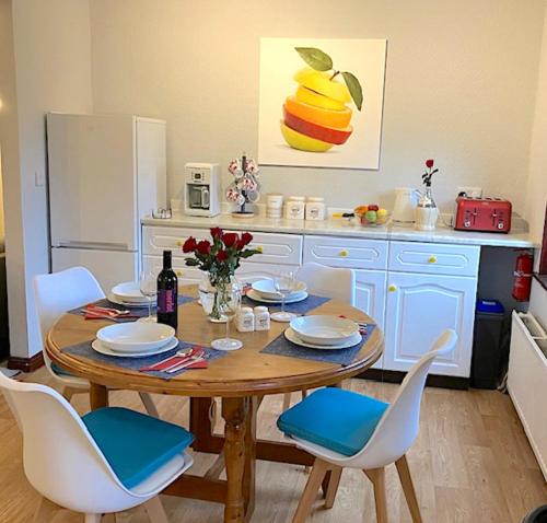 a kitchen with a wooden table with chairs and a dining room at 2 bed House with office in Historic Richmond in Richmond