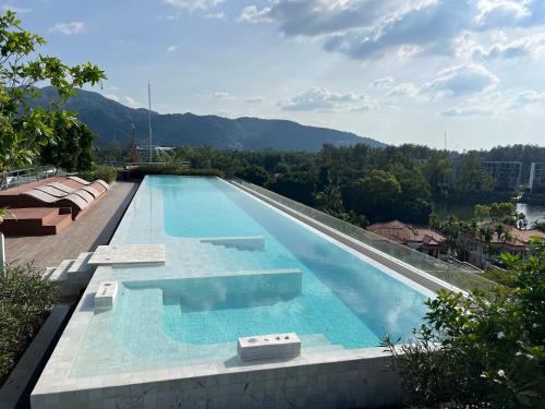 a swimming pool on top of a building at Modern 2-bedroom Apartments Garden view in Skypark Laguna Bang Tao in Bang Tao Beach