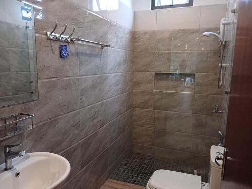 a bathroom with a shower and a toilet and a sink at Peaceful Nest in Mont Choisy in Grand Baie