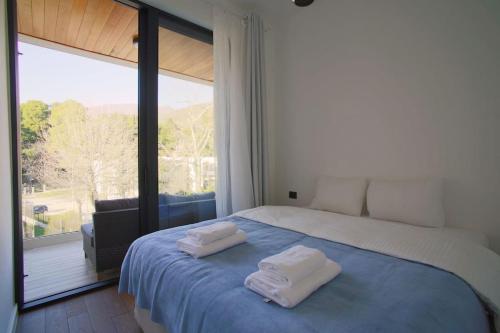 a bedroom with a bed with two towels on it at Park Residence 7 - 1 bd apartment in Tivat Center in Tivat