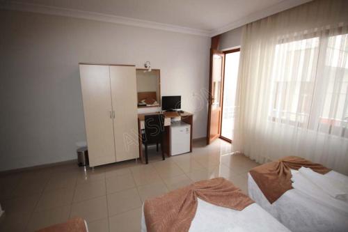 Zimmer mit einem Schlafzimmer mit einem Schreibtisch und einem Fenster in der Unterkunft Turan Hotel in Atakum