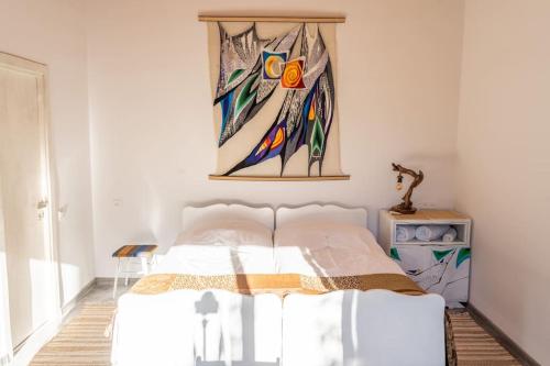 a bedroom with a bed with a painting on the wall at Art Rooms Garni (Blue Edition) in Garni