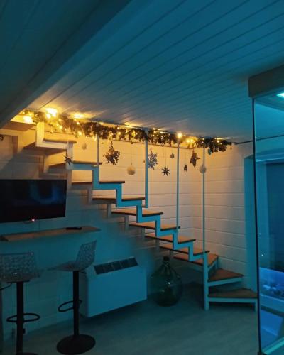 a room with stairs with christmas lights on the wall at GILU' in Adelfia