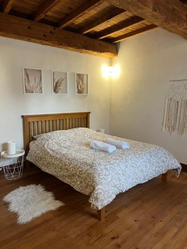 a bedroom with a bed with two pillows on it at Domaine Saladry in Villepinte