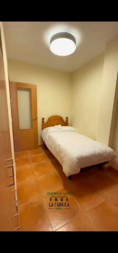Katil atau katil-katil dalam bilik di Apartamento Calamina