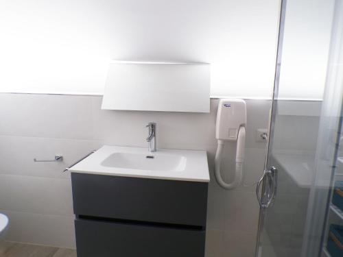 a bathroom with a sink and a shower at GRAZIA’S HOUSE in Mistretta