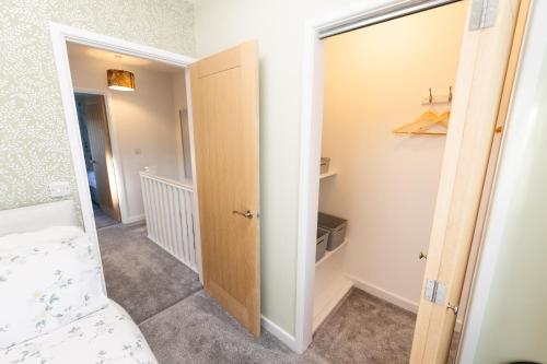 a small bedroom with a bed and a closet at One Bridge End in Pevensey