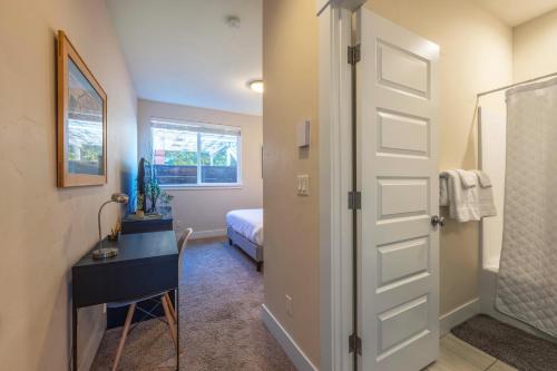 a room with a door and a desk and a bed at Hull Street Loft in Hood River