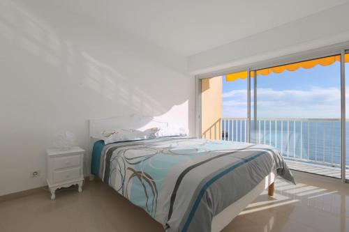 a bedroom with a bed and a large window at BRIDGESTREET MONACO - cap d ail - roquebrune in Saint-Antoine