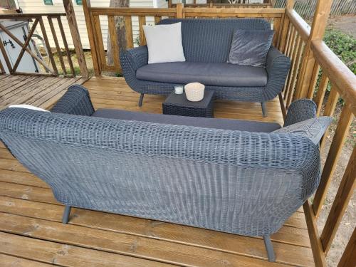 a patio with two chairs and a couch on a deck at mobil home v198 in Sigean