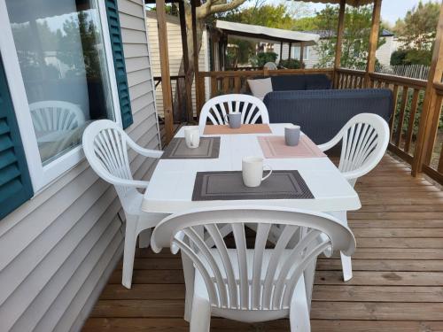 a white table and chairs on a porch at mobil home v198 in Sigean